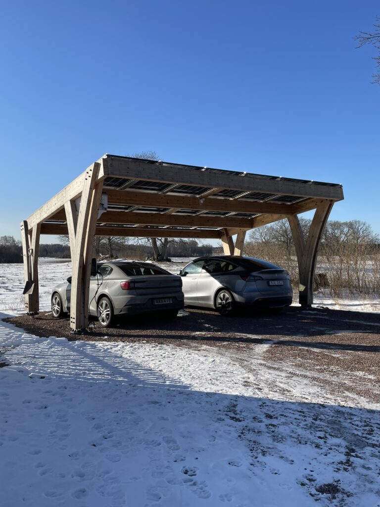 Carport with cars underneath in a snow landscape